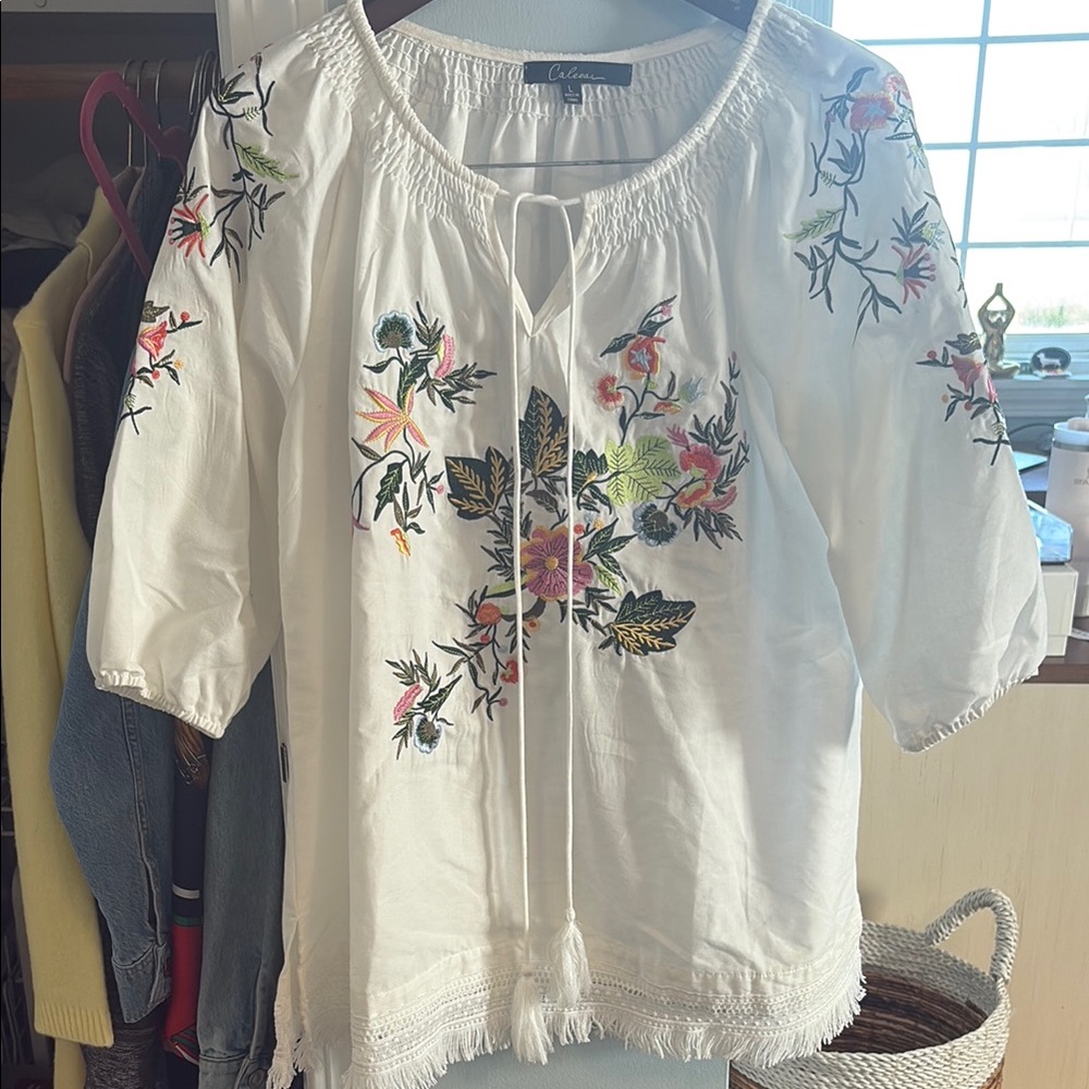 Calessa Women's White Floral Embroidered Top with fringed bottom and tassel ties